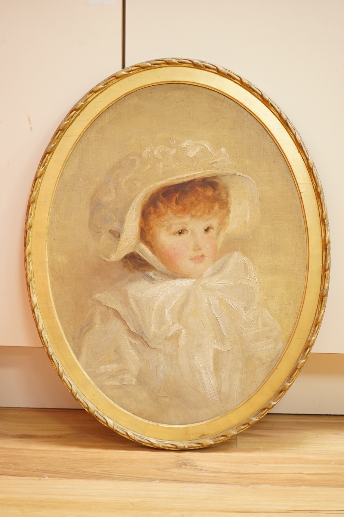 Ivan Lindhe (1875-1954), Head and shoulders portrait of a young girl wearing a bonnet, signed and dated 1910, oval oil on canvas, 58 x 44cm, gilt frame